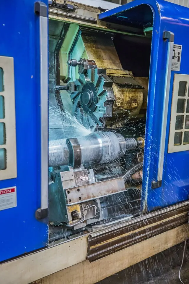 CNC turning of a large shaft with coolant spray on the Vikrant Forge shop floor